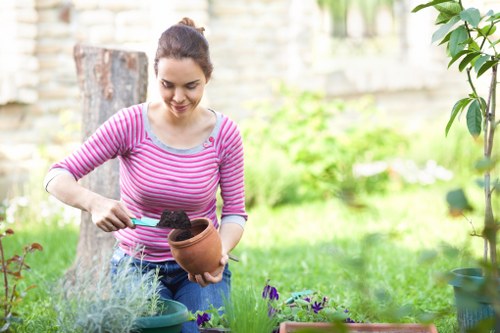 Landscaper using proper manual handling techniques